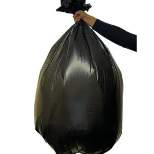 A person hand holding a black bag filled with trash